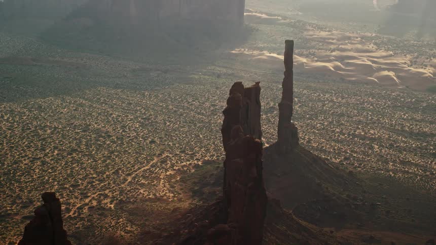 Aerial of a butte formation in a desert on an open landscape during a sunny day