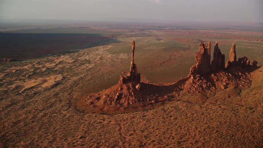 A very tall but very thin rock formation in the desert