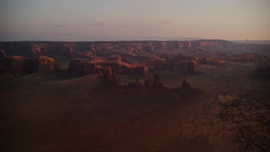 Aerial landscape shot of mountain region with canyons during dusk or dawn