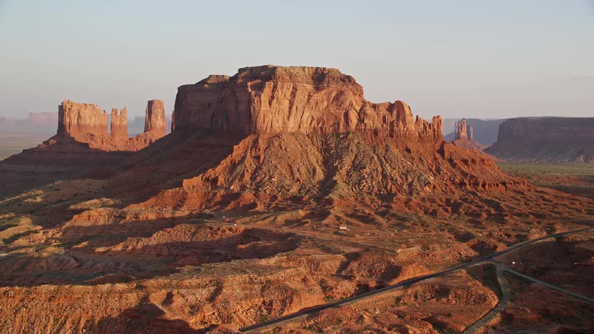 Aerial view of roads around a natural area with canyons during the late afternoon sun