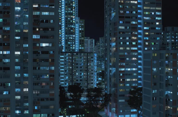 Time lapse of city buildings lit up at night and the lights turning off