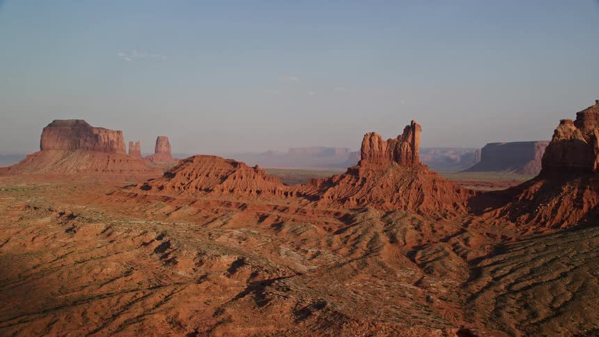 Aerial of butte rock formations in the desert with ridges leading to valleys