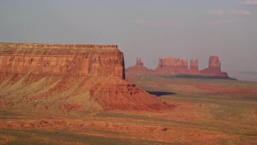 A tall and thin rock formation in the desert