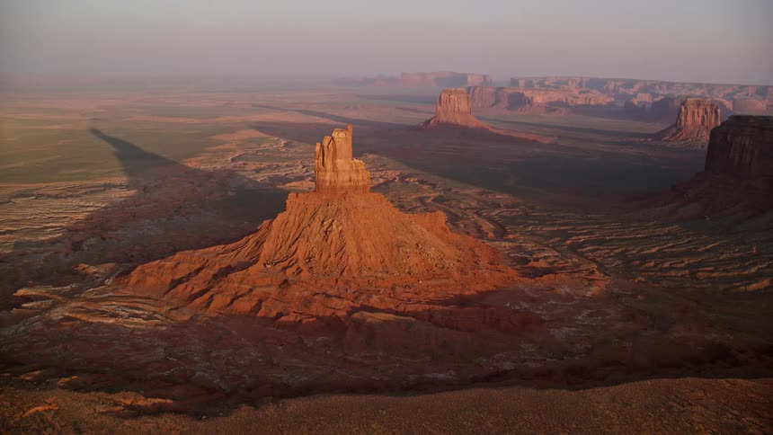 Aerial view of a valley with a rocky peak formation