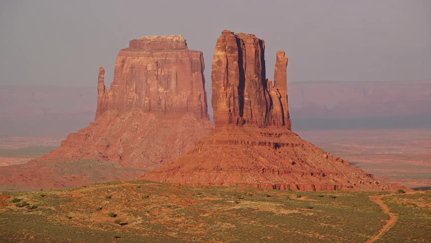 Aerial of two butte formations in the desert during a bright sunny day
