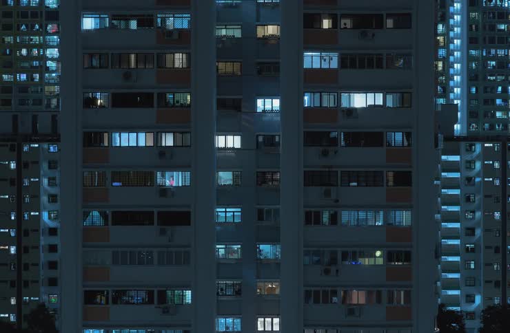 Lights turning off in urban city apartments at night