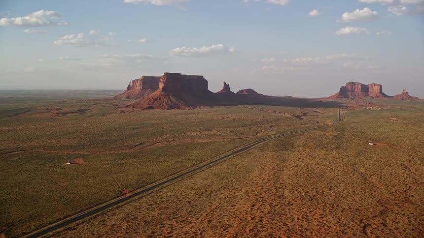 Aerial view of a road amidst a natural environment with rocky and geological mountains