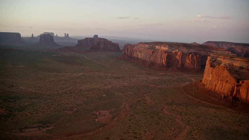 An aerial view of a desert region with some rock formations