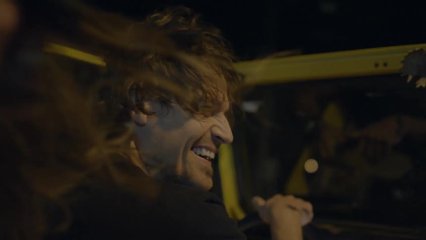 People are riding in a car at night