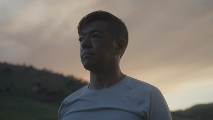 Portrait of a man observing in the midst of nature in an open space
