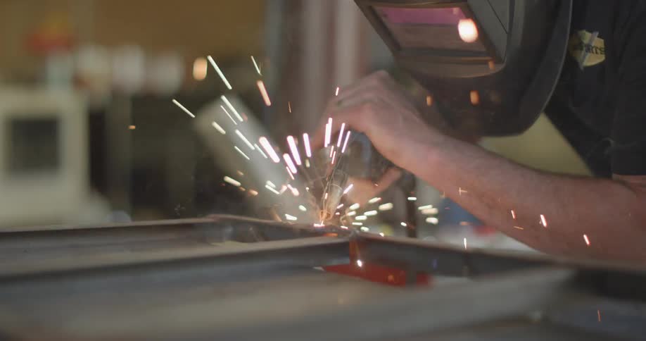 A man is welding with a mask on