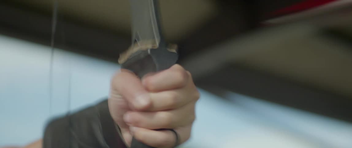 Closeup of a persons hands holding and shooting an arrow with a bow