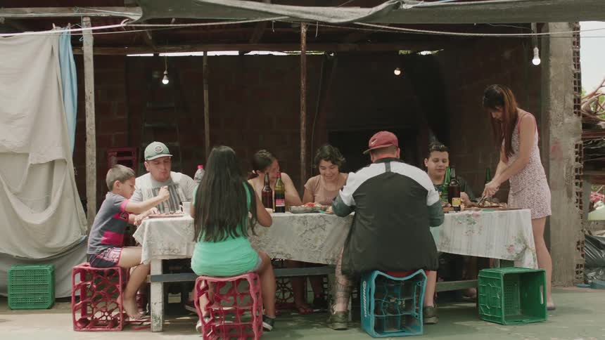 A family having lunch in their backyard