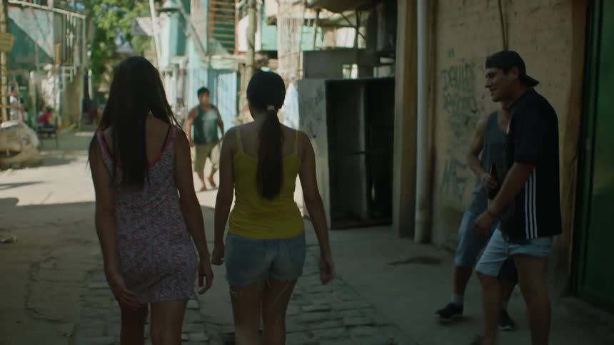 Two women walking on a residential street when two men start harassing them and one of the women pushes back in response