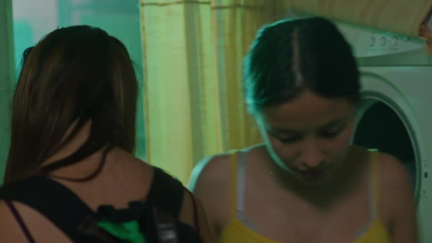 Woman doing laundry at home says goodbye to her sister