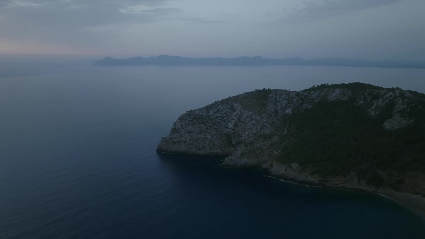 Aerial of a deserted beach with rocky mountains