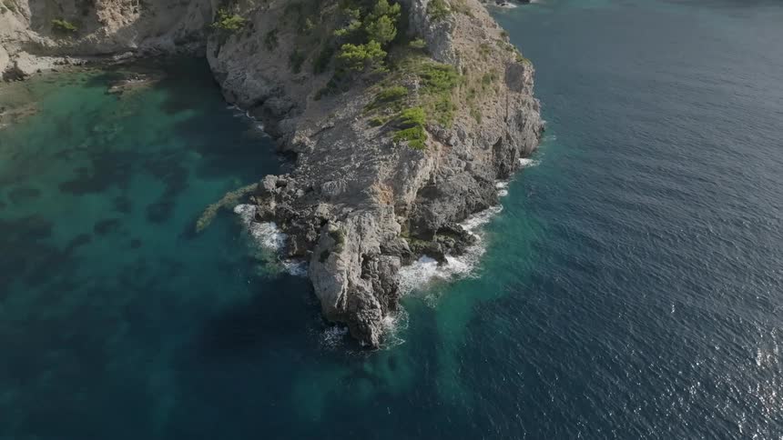 Aerial view of the coastline of a turquoise blue sea