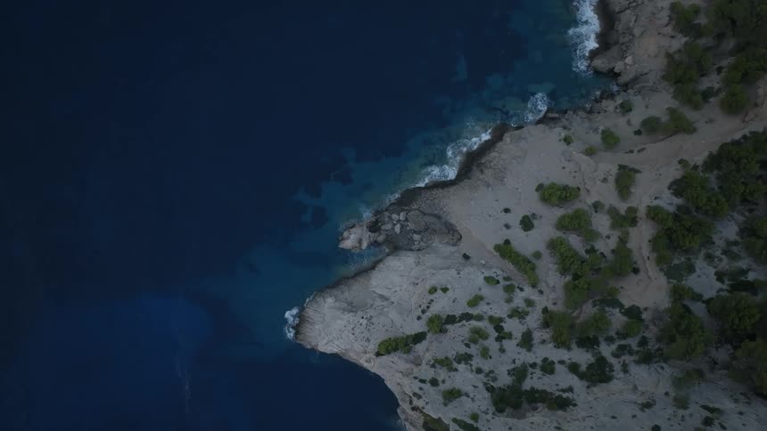 Aerial of a deserted island with a sea of blue water