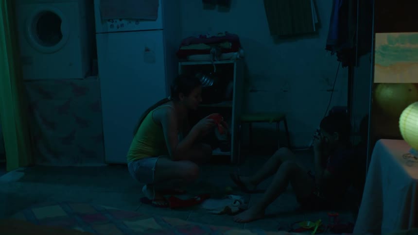 A mother talking to her son in an indoor setting in the house at night