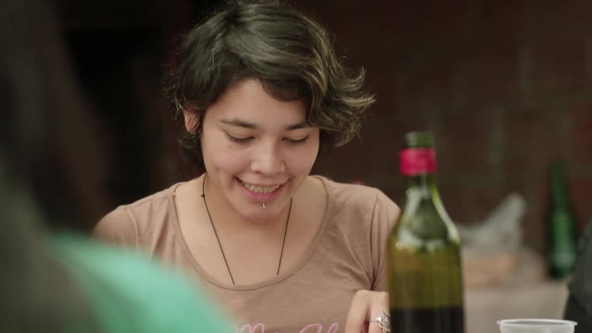 A young woman cuts the meat on the food plate