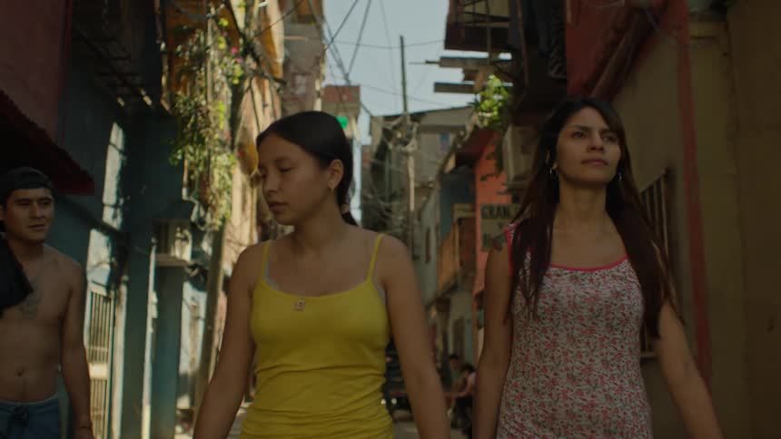 Women walking on an alley reject two men catcalling them