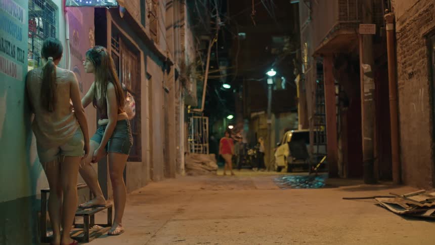 Two women going to a convenience store in a neighborhood at night and buying a soda