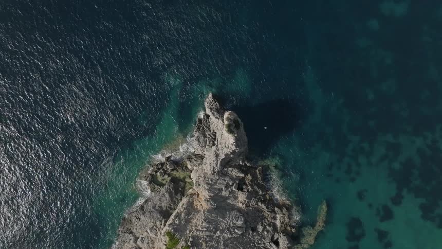 Aerial view of the coastline along a turquoise sea