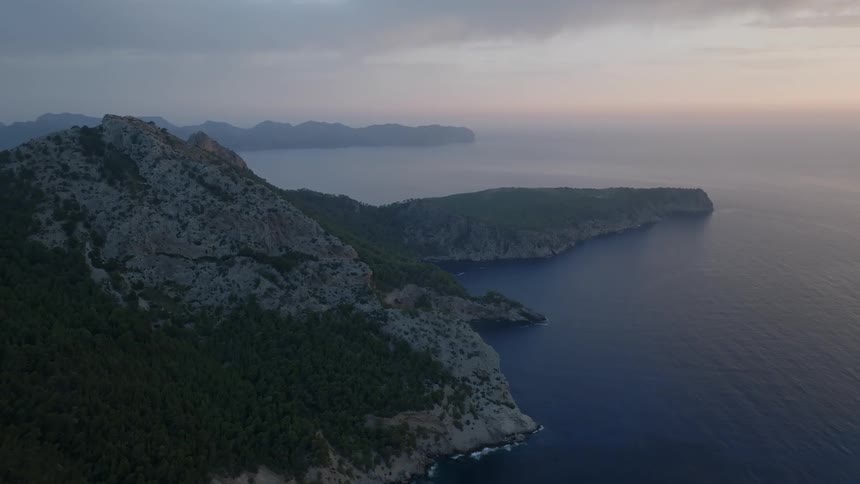 A peninsula surrounded by a huge ocean and a mountain behind