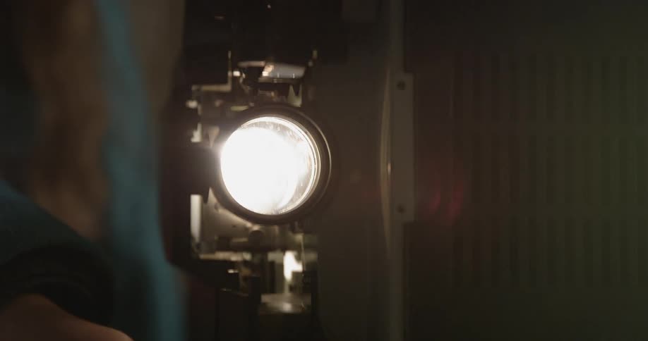 A person turns on a projector light