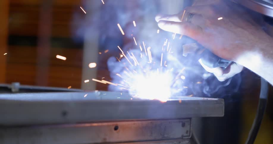 A man is welding with a mask on