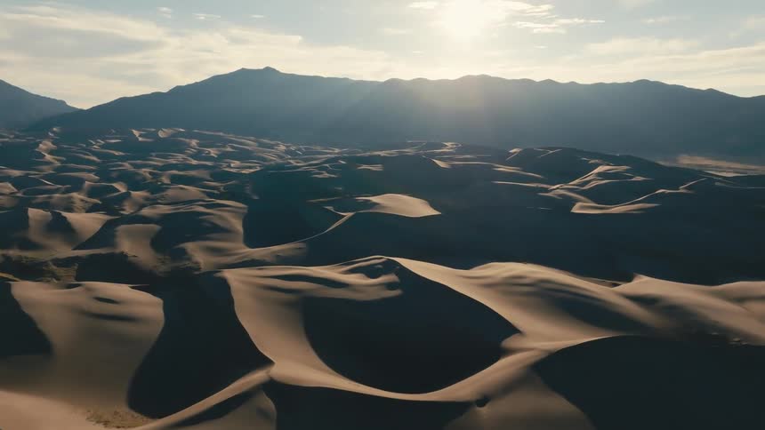 Aerial view of the desert with the sun in the background