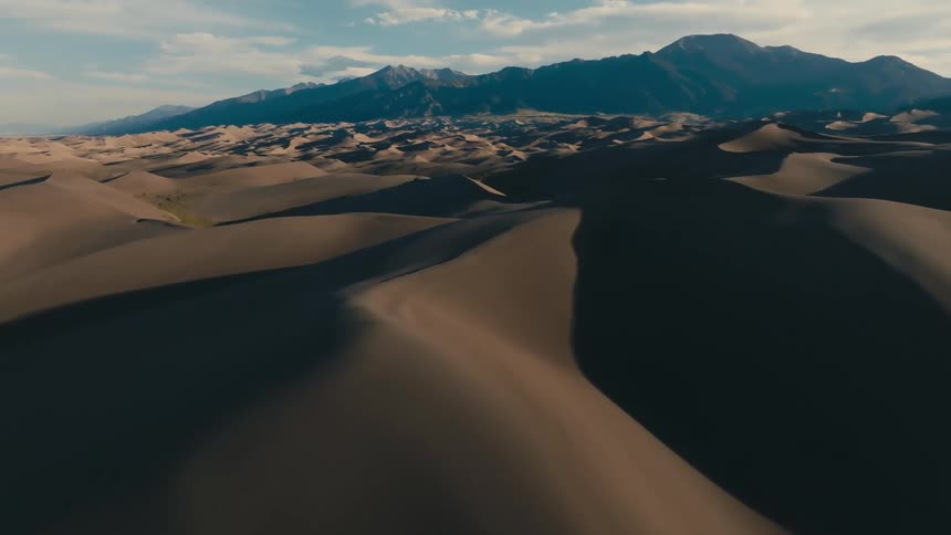 Aerial view of the desert with mountains in the background