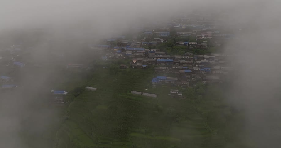 Low lying clouds obscure portions of residential neighborhood