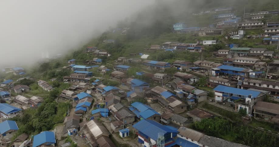 Bhujung village unfurls below like a vibrant tapestry its patchwork fields traditional stone houses and winding pathways painting a picturesque tableau when viewed from the skies above