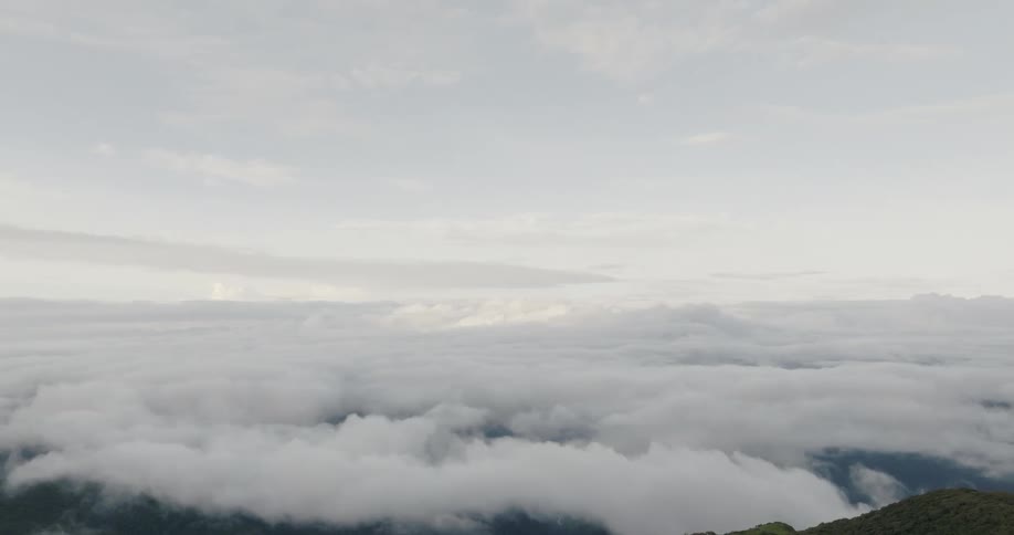 Aerial view of white clouds over the mountains at evening