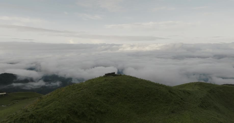 Ruins on hill overlook structures near fog covered terrain
