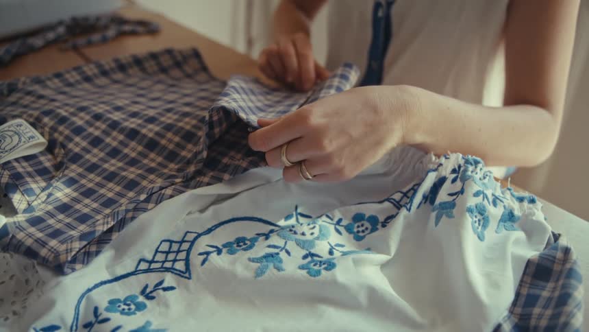 A person taking measurements of a piece of clothing