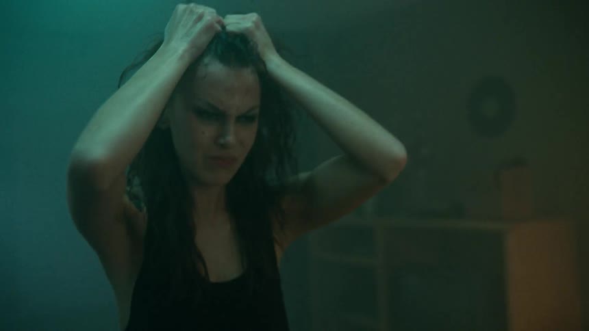 A woman with her hands in her hair screaming in anger