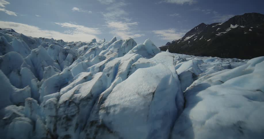 Peaks and cliffs with ice formations and mountains on the sides