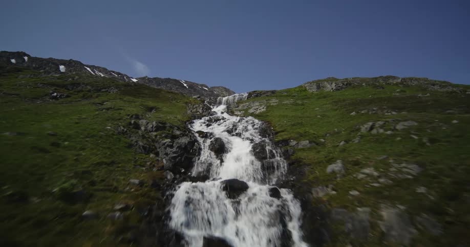 Aerial of a waterfall on top of a mountain