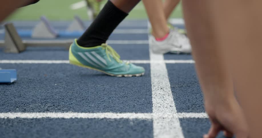 Athletes prepare for a race on a racetrack