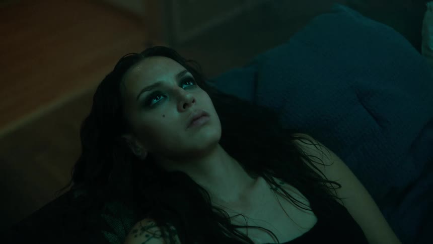 A woman lays down in bed