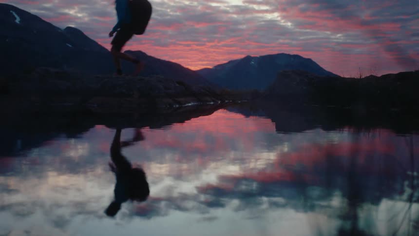 Reflection of a person reflecting in the water of a lake at sunset