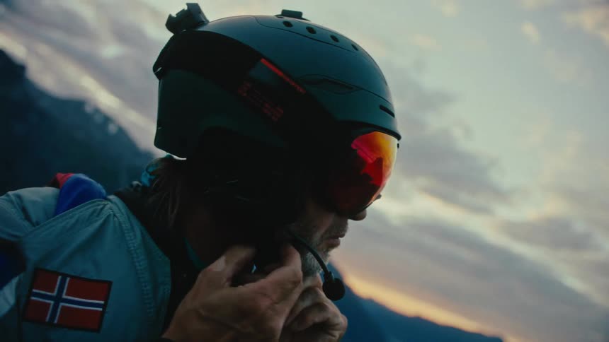 A man puts a visor over his helmet