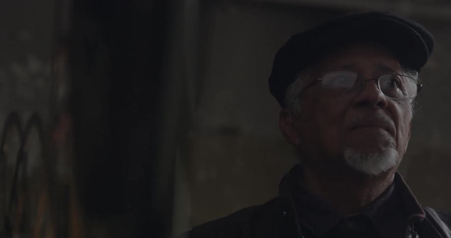 A man is standing near a projector