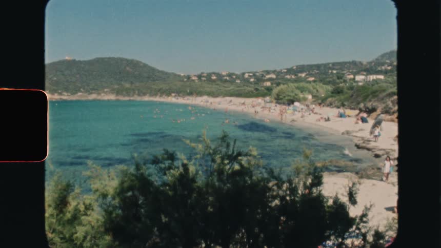 Super 8 film of people are enjoying the summer on a paradisiacal beach with a blue sea