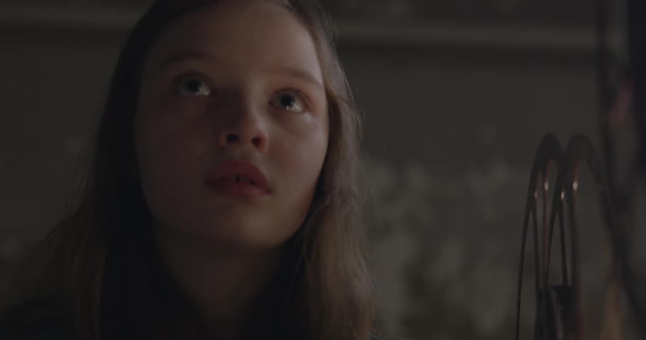 A girl looks at the display ahead of a projector