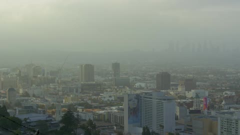 The city ahead has heavy fog around it