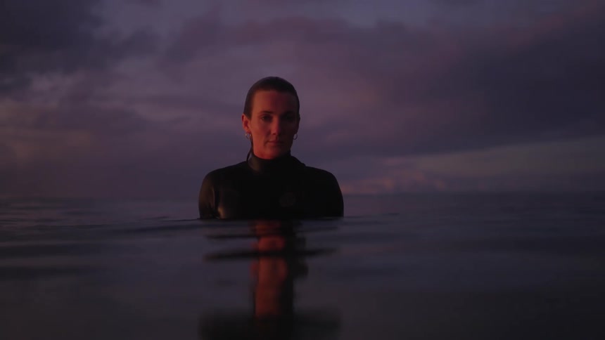 A portrait of a girl in the ocean at sunset
