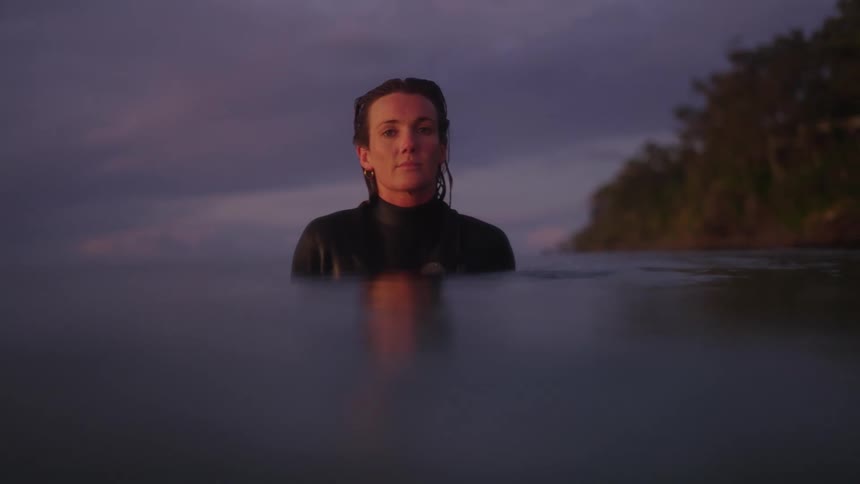 Portrait of a woman in the sea during a late afternoon